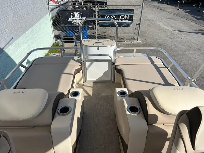 Slide: The Image of 2025 Avalon 2385 LSZ Rear Lounger with beige seating and cup holders on a sunny day. - 9