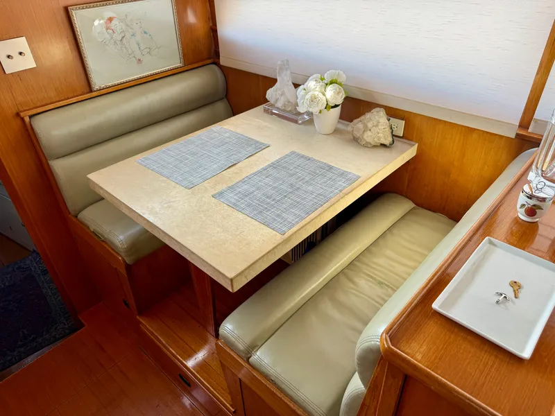 Slide: The Image of 1972 Stephens Brothers Flush Deck Motoryacht interior with cozy dining area and elegant decor. - 17