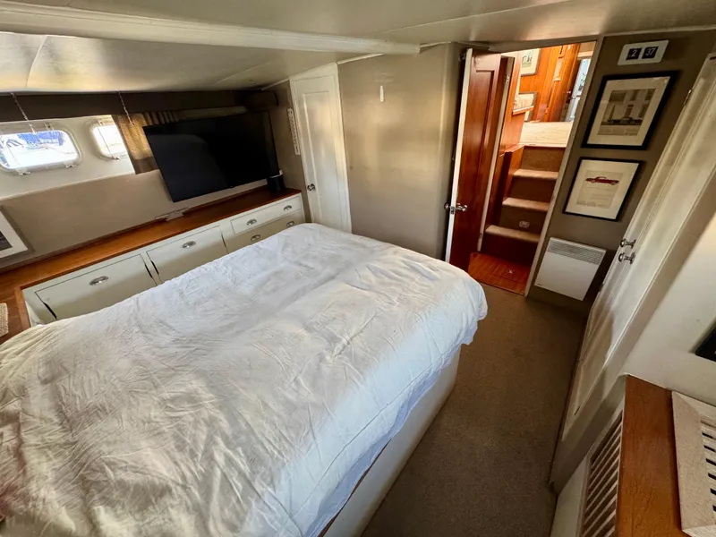 Slide: The Image of Interior of 1972 Stephens Brothers Flush Deck Motoryacht bedroom with bed and storage. - 18
