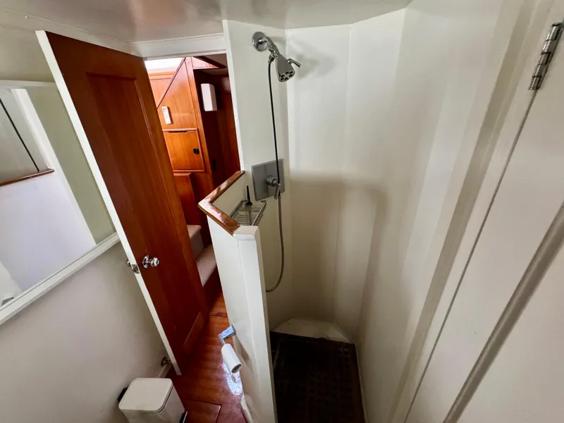 Slide: The Image of Shower area in a 1972 Stephens Brothers Flush Deck Motoryacht, featuring wooden accents. - 19