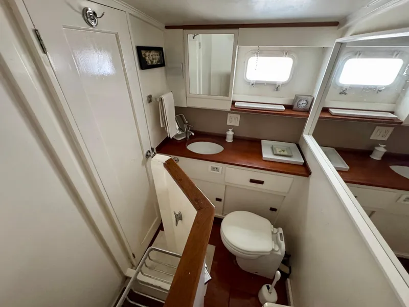 Slide: The Image of 1972 Stephens Brothers Flush Deck Motoryacht bathroom with wooden accents and compact design. - 20