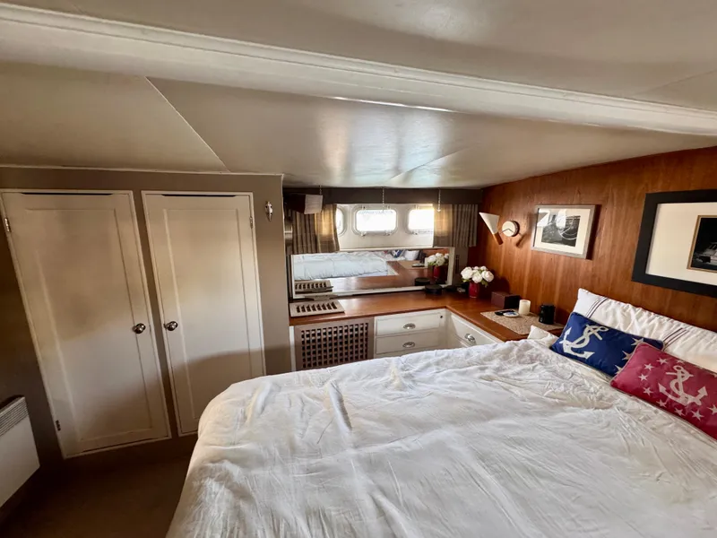 Slide: The Image of 1972 Stephens Brothers Flush Deck Motoryacht bedroom with cozy decor and nautical-themed pillows. - 23