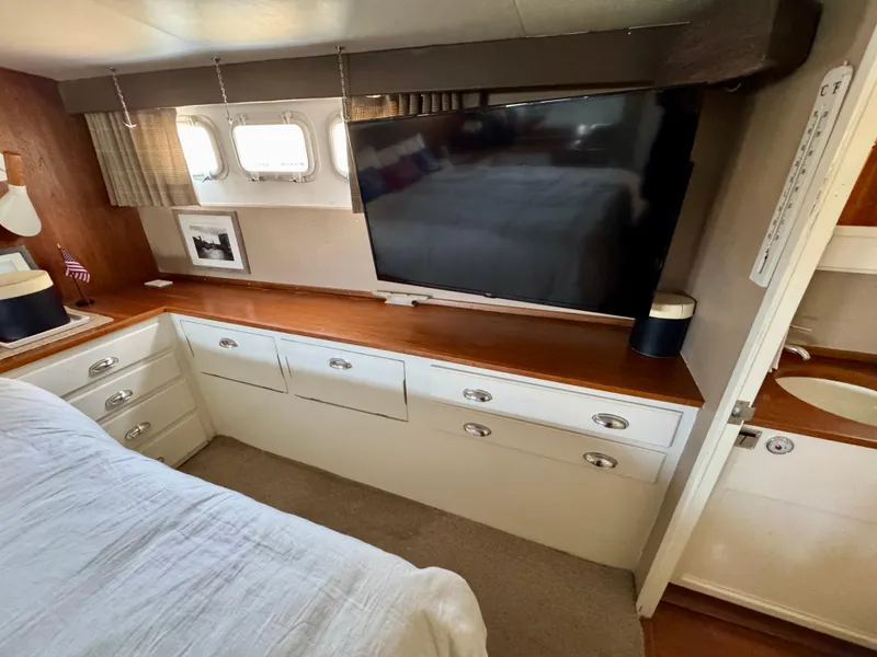 Slide: The Image of 1972 Stephens Brothers Flush Deck Motoryacht interior with TV, drawers, and porthole windows. - 24