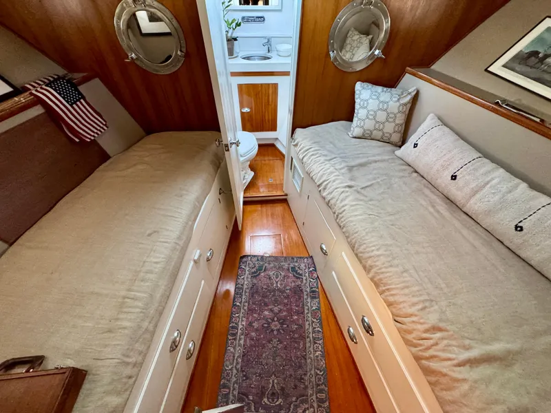 Slide: The Image of 1972 Stephens Brothers Flush Deck Motoryacht cabin with twin beds and wooden interior. - 25