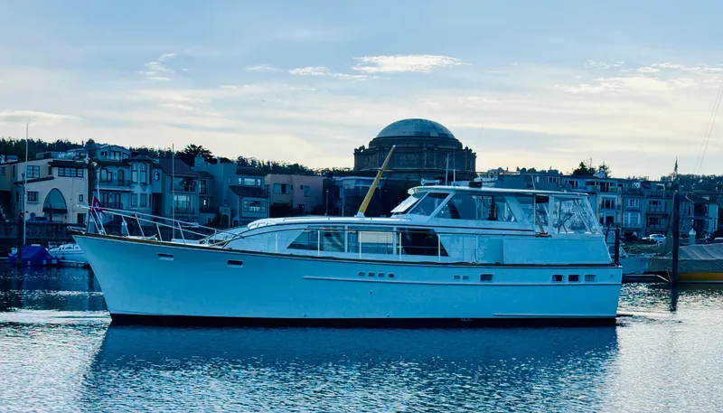 Slide: The Image of 1972 Stephens Brothers Flush Deck Motoryacht on calm water with cityscape background. - 26