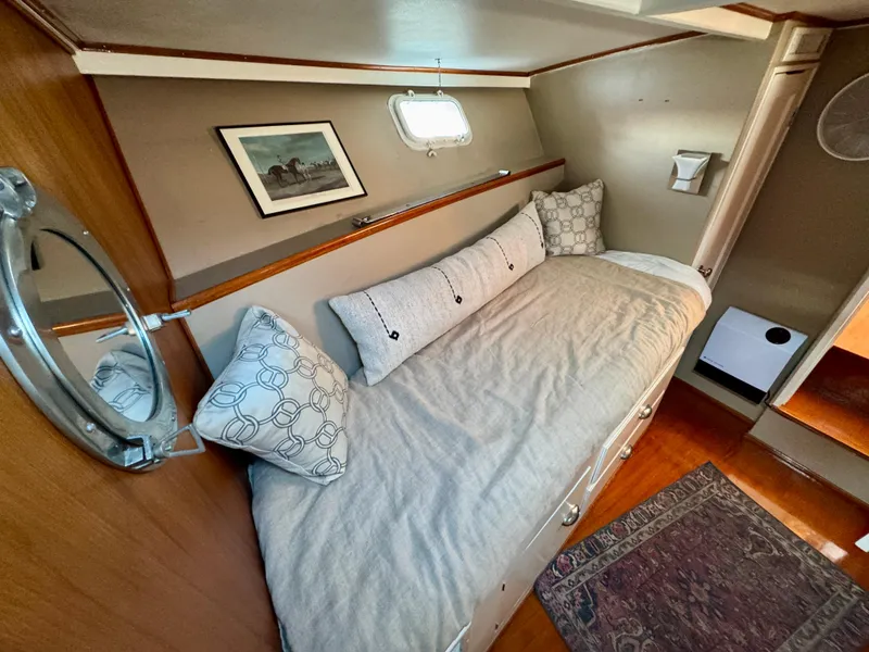 Slide: The Image of 1972 Stephens Brothers Flush Deck Motoryacht cabin with cozy bed and nautical decor. - 27