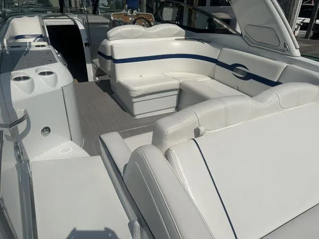 Slide: The Image of 2008 Formula 310 Sun Sport boat interior with white seating and blue accents. - 11