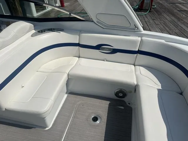 Slide: The Image of 2008 Formula 310 Sun Sport boat interior with white seating and blue accents. - 13