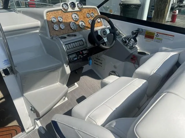 Slide: The Image of 2008 Formula 310 Sun Sport boat interior with sleek dashboard and white seating. - 14