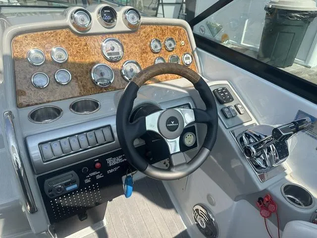 Slide: The Image of 2008 Formula 310 Sun Sport boat dashboard with steering wheel and control panel. - 15