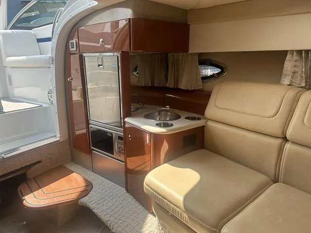 Slide: The Image of Interior of 2008 Formula 310 Sun Sport boat with kitchenette and seating area. - 21