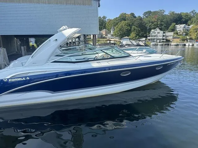 Slide: The Image of 2008 Formula 310 Sun Sport boat docked on calm water. - 3