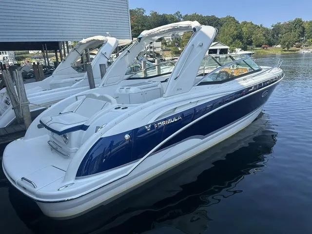 Slide: The Image of 2008 Formula 310 Sun Sport boat docked on calm water. - 5