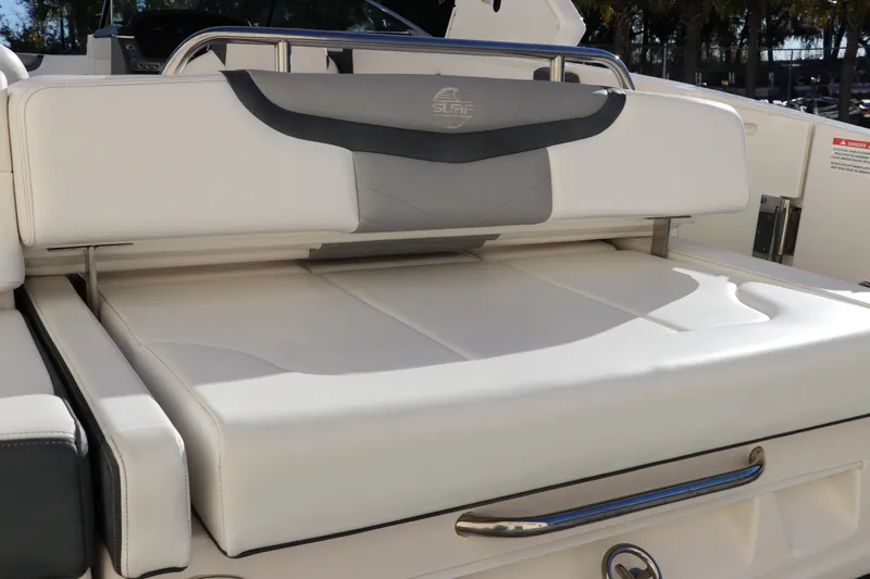 Slide: The Image of 2021 Chaparral 30 Surf boat with luxurious white seating and sleek design. - 10