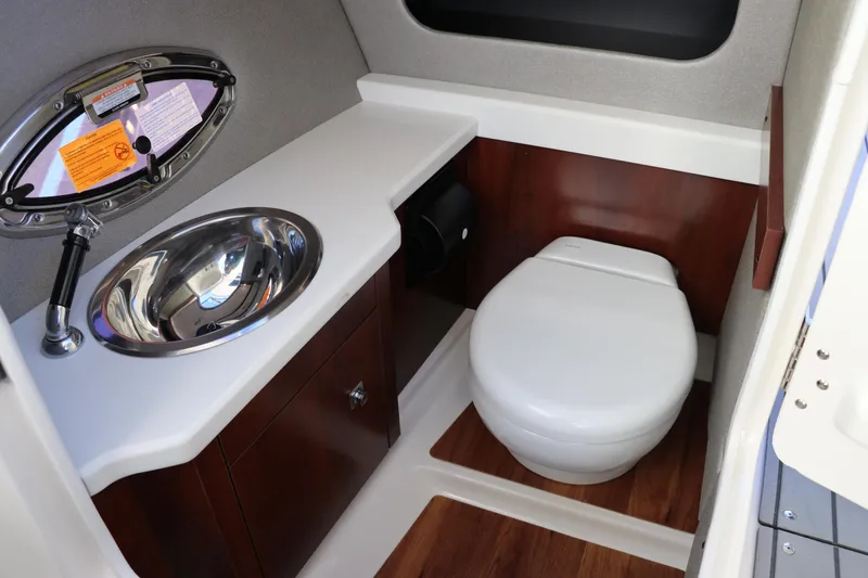 Slide: The Image of 2021 Chaparral 30 Surf boat bathroom with sink and toilet. - 18
