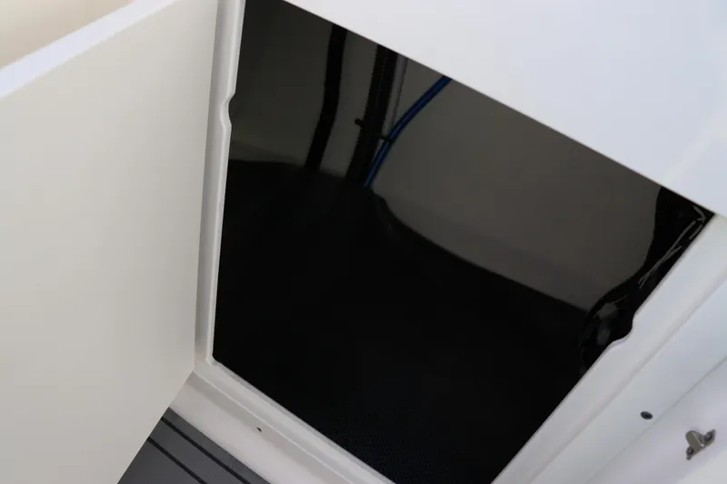 Slide: The Image of 2021 Chaparral 30 Surf boat storage compartment with open door. - 19