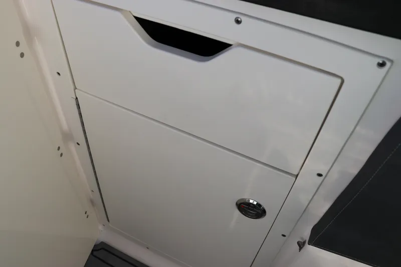 Slide: The Image of 2021 Chaparral 30 Surf boat storage compartment with sleek white finish. - 20