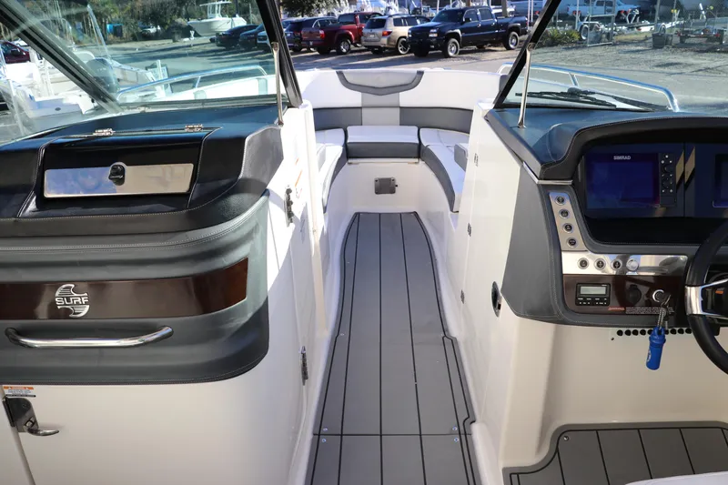 Slide: The Image of 2021 Chaparral 30 Surf boat interior with modern dashboard and seating area. - 21