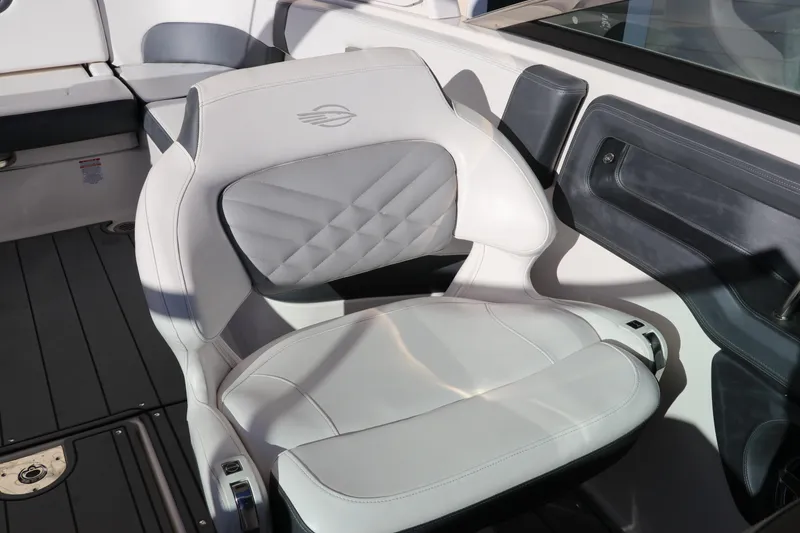 Slide: The Image of 2021 Chaparral 30 Surf boat interior with white cushioned seating. - 22