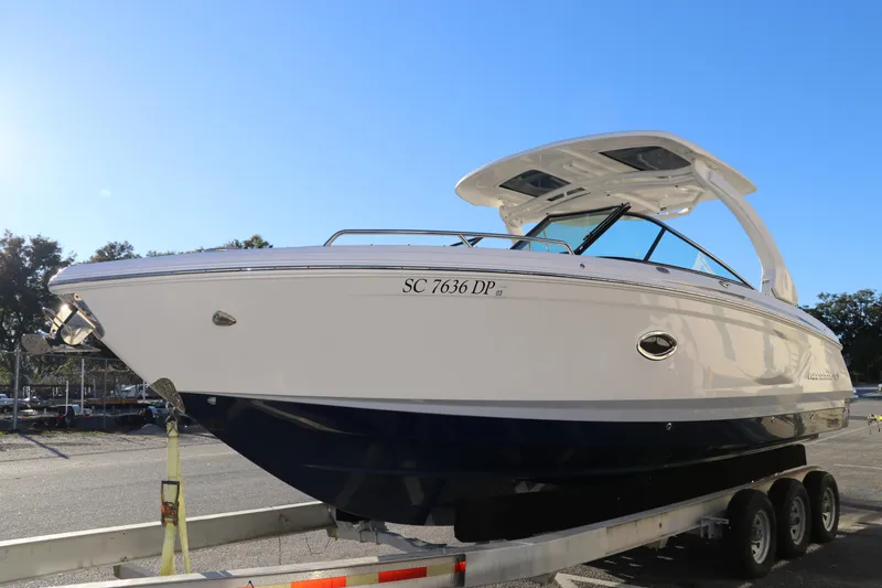 Slide: The Image of 2021 Chaparral 30 Surf boat on trailer, side view, sunny day. - 3