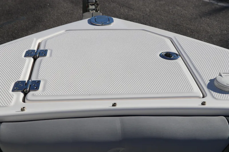 Slide: The Image of 2021 Chaparral 30 Surf boat deck with textured surface and metal hinges. - 33
