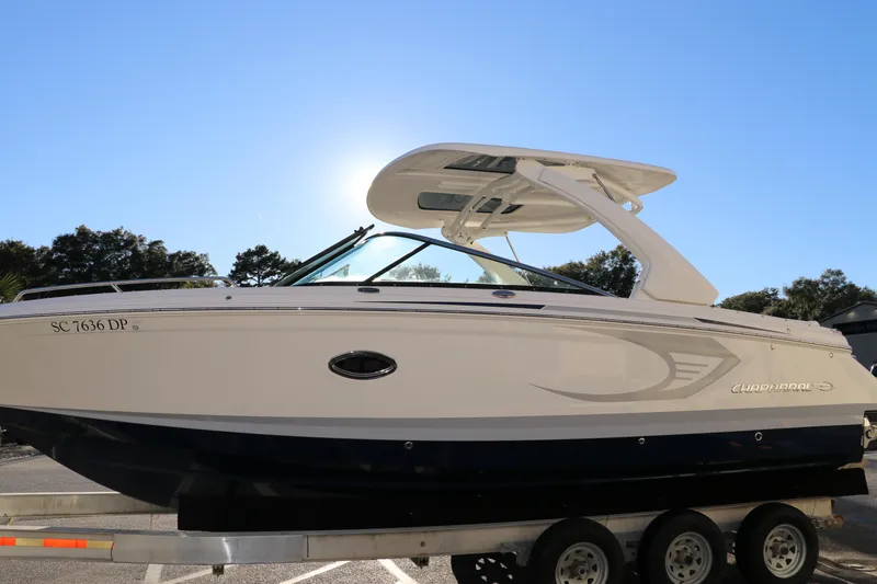 Slide: The Image of 2021 Chaparral 30 Surf boat on trailer under clear blue sky. - 4