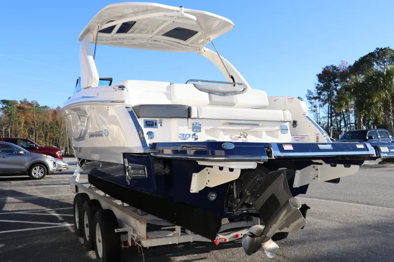 Slide: The Image of 2021 Chaparral 30 Surf boat on trailer, rear view, sunny day. - 7