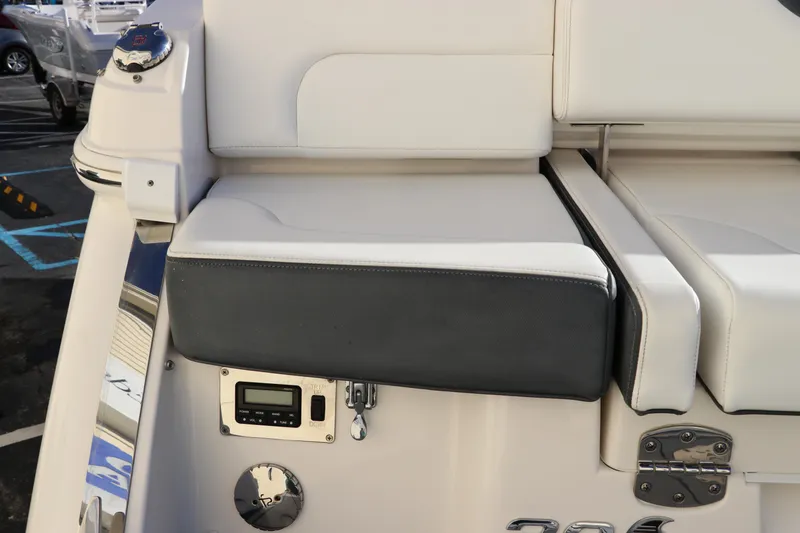 Slide: The Image of 2021 Chaparral 30 Surf boat seating area with control panel and sleek design. - 9
