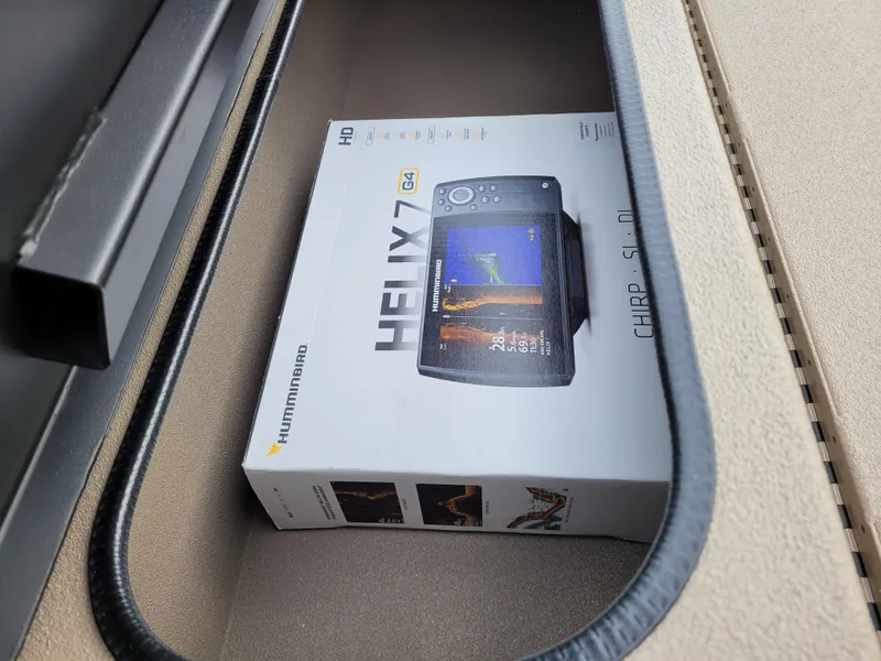 Slide: The Image of Boxed Humminbird Helix 7 fish finder inside a compartment of a 2025 Excel 1960 Stalker SC. - 4
