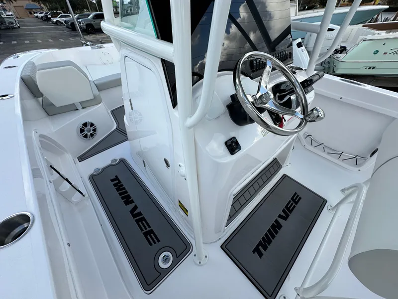 Slide: The Image of 2025 Twin Vee 240 GFX CC boat interior with steering wheel and seating area. - 10