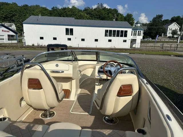 Slide: The Image of 2018 Chris-Craft Launch 23 boat interior with beige seating and wooden accents. - 11