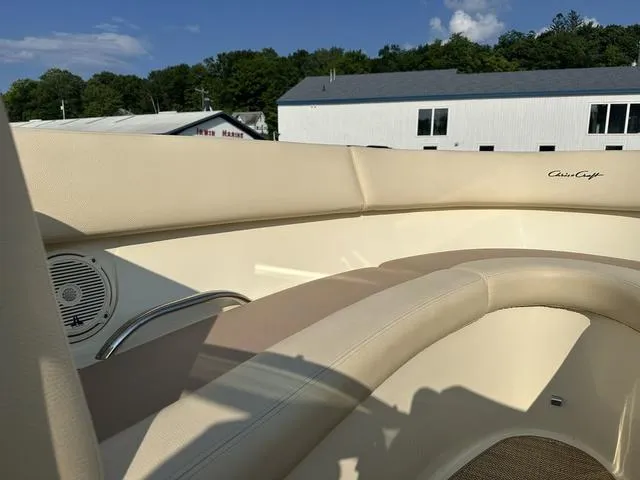 Slide: The Image of 2018 Chris-Craft Launch 23 boat interior with beige seating and speaker. - 15
