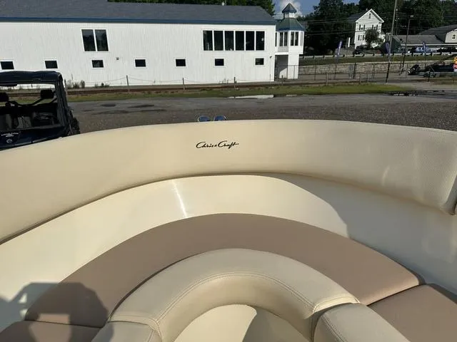 Slide: The Image of 2018 Chris-Craft Launch 23 boat interior with beige seating and logo. - 17