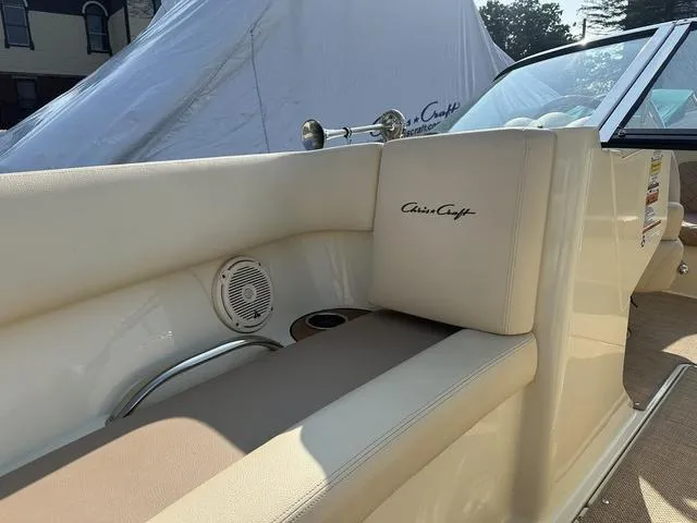 Slide: The Image of 2018 Chris-Craft Launch 23 boat interior with beige seating and branded logo. - 18