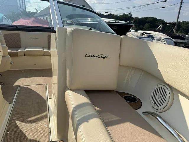 Slide: The Image of 2018 Chris-Craft Launch 23 interior with beige seating and branded upholstery. - 19