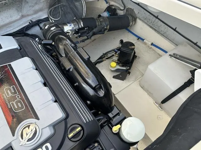 Slide: The Image of Engine compartment of a 2018 Chris-Craft Launch 23 boat, showcasing detailed components. - 26