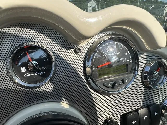 Slide: The Image of 2018 Chris-Craft Launch 23 dashboard with fuel and RPM gauges. - 27