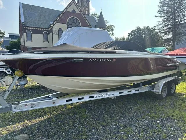 Slide: The Image of 2018 Chris-Craft Launch 23 boat on trailer, parked near a historic building. - 28