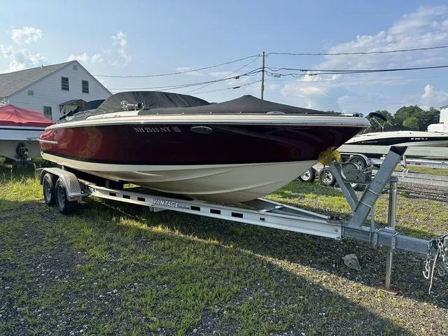 Slide: The Image of 2018 Chris-Craft Launch 23 boat on trailer, parked outdoors. - 29