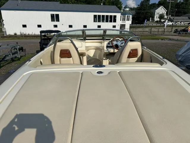 Slide: The Image of 2018 Chris-Craft Launch 23 boat with beige interior, parked outdoors. - 8