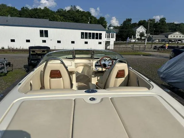 Slide: The Image of 2018 Chris-Craft Launch 23 boat with beige interior, parked outdoors. - 9