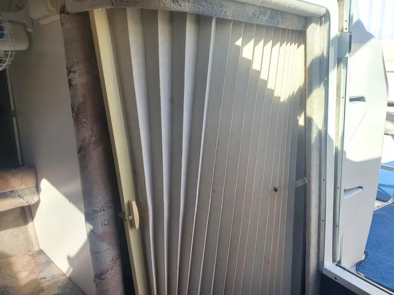 Slide: The Image of 1996 Sea Ray 215 Express Cruiser cabin interior with folding door. - 12