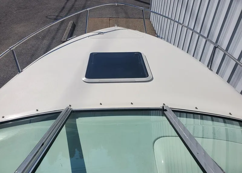 Slide: The Image of 1996 Sea Ray 215 Express Cruiser boat deck with hatch and railing. - 14