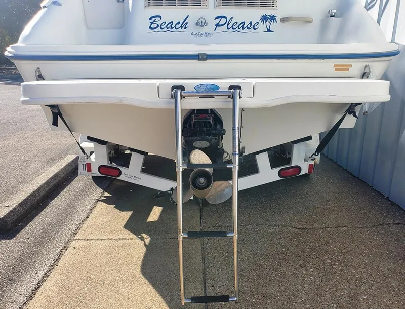 Slide: The Image of 1996 Sea Ray 215 Express Cruiser boat with ladder and "Beach Please" decal. - 18