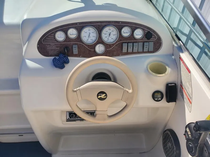 Slide: The Image of Steering console of a 1996 Sea Ray 215 Express Cruiser with gauges and controls. - 22