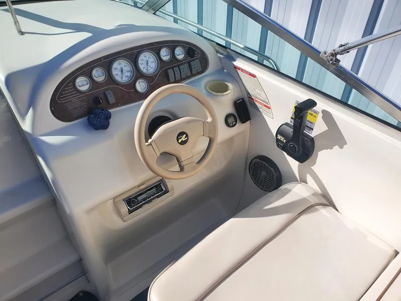 Slide: The Image of 1996 Sea Ray 215 Express Cruiser helm with steering wheel and instrument panel. - 3