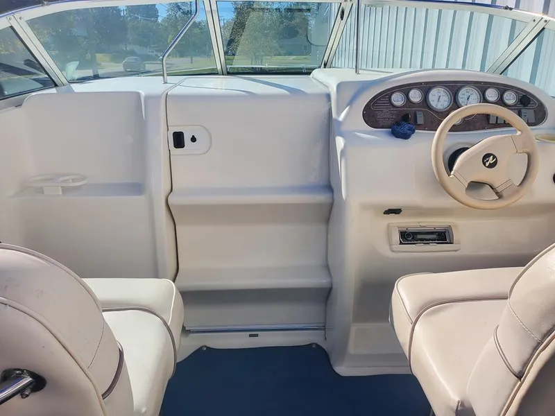 Slide: The Image of 1996 Sea Ray 215 Express Cruiser cockpit with steering wheel and dashboard. - 7