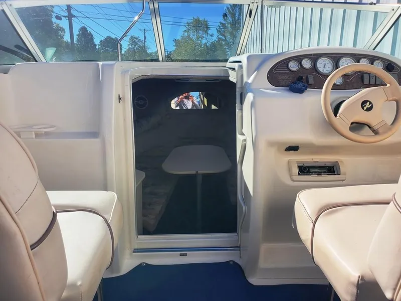 Slide: The Image of 1996 Sea Ray 215 Express Cruiser interior with steering wheel and cabin entrance. - 8