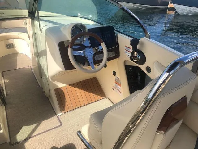 Slide: The Image of 2022 Chris-Craft Launch 28 GT boat interior with modern dashboard and steering wheel. - 10
