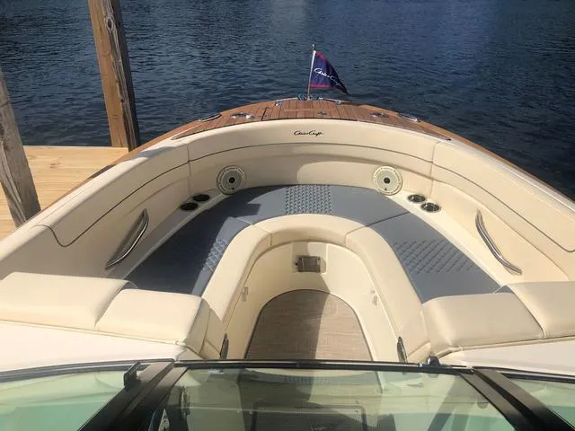 Slide: The Image of 2022 Chris-Craft Launch 28 GT boat with elegant seating and teak accents on a sunny day. - 11